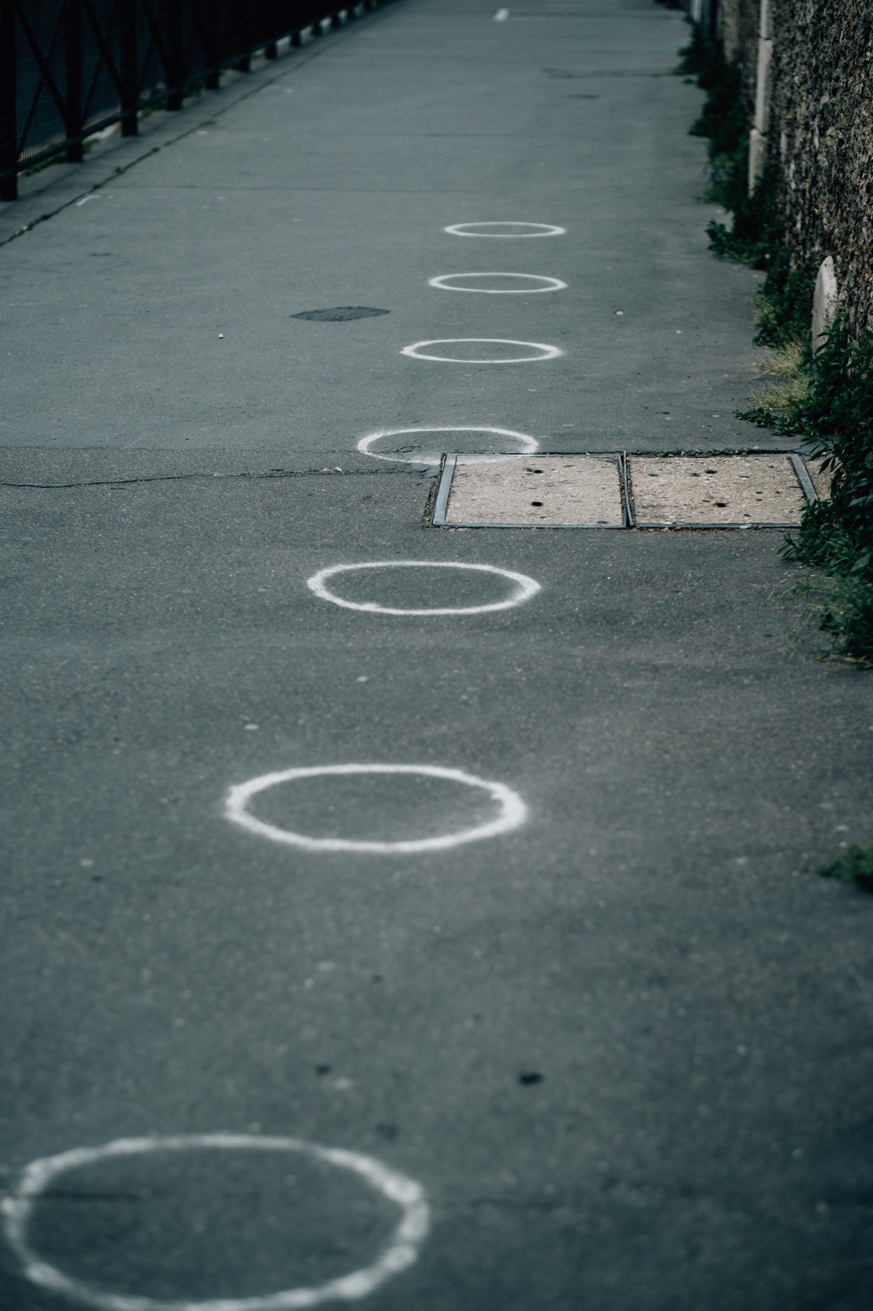 paved-sidewalk-with-white-painted-circles